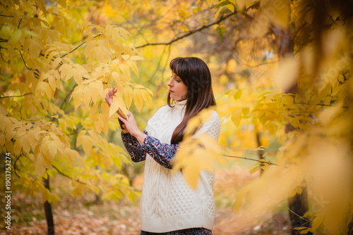 Golden Autumn: Harmony of Nature and Humanity. A Woman Among Leaves in Autumn