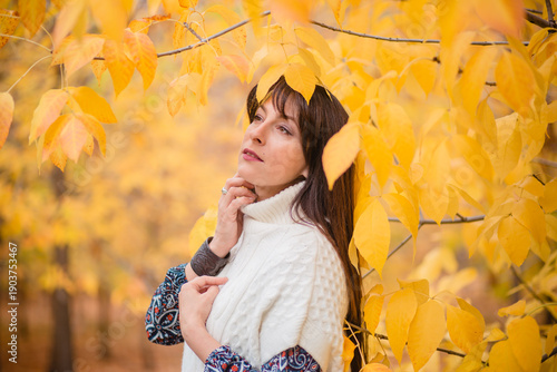 Golden Autumn: Harmony of Nature and Humanity. A Woman Among Leaves in Autumn