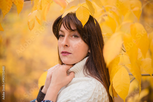 Golden Autumn: Harmony of Nature and Humanity. A Woman Among Leaves in Autumn
