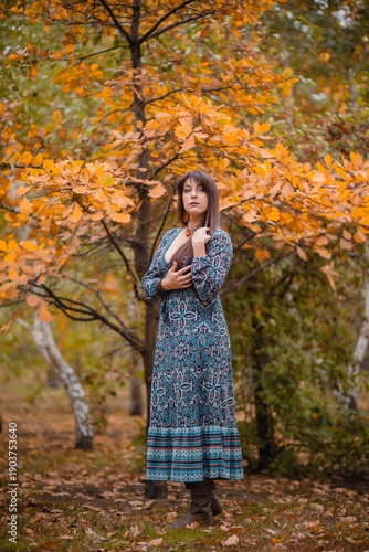 Golden Autumn: Harmony of Nature and Humanity. A Woman Among Leaves in Autumn