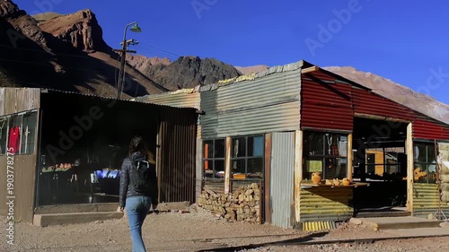 Female Traveler Approaching Local Store in Puente del Inca Village, Argentina - 4K