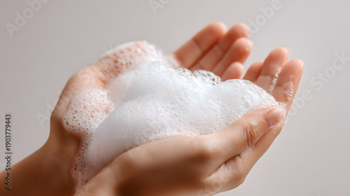 Hands cupped with soap foam for cleaning and hygiene