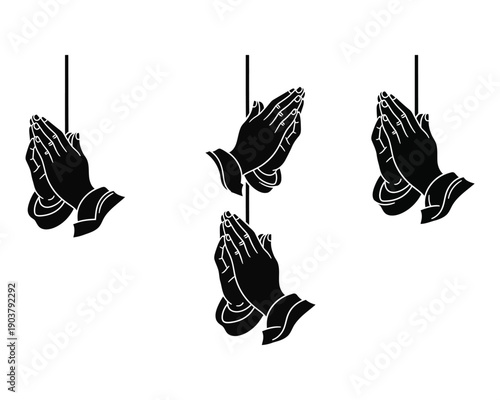Three pairs of praying hands hanging from strings in a prayerful gesture