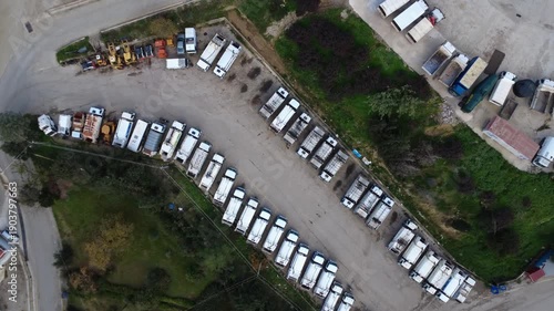 Top down municipal garbage truck fleet arranged in structured service facility