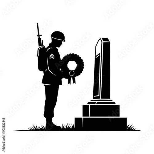 A soldier pays respects at a memorial head bowed in remembrance