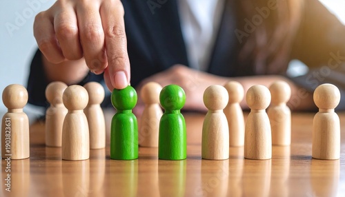 Wallpaper Mural Businessman Selecting Green Figurine – Symbol of Leadership and Recruitment Torontodigital.ca