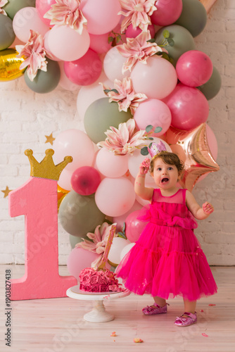 Baby girl  at first birthday with smash cake