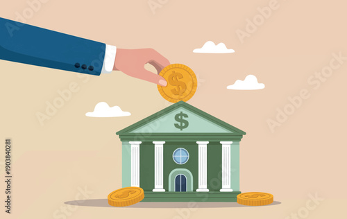Hand putting a gold dollar coin into a bank building representing savings and investment.