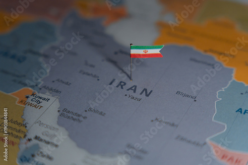 Iran flag pinned on political map over Iran in Middle East region