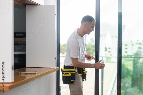 man installing aluminum frame sliding terrace doors