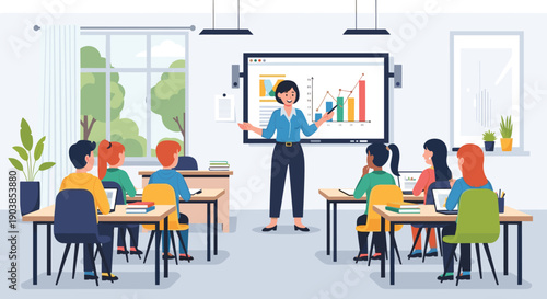 Female teacher explaining a business growth chart on a digital screen to young students sitting at desks with laptops in a bright modern classroom