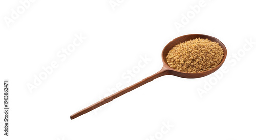A wooden spoon filled with yellow grains on a black background