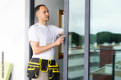 man installing aluminum frame sliding terrace doors