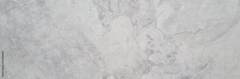 Obraz premium Close-up of a smooth, light gray marble texture with subtle veining and natural patterns. Ideal for backgrounds or design elements.