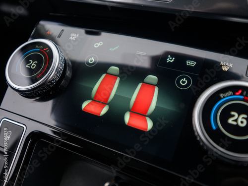 Heated seat controls on car climate control touchscreen and dials