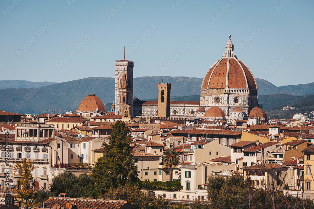 Fototapeta premium A breathtaking perspective of Florence captures the grandeur of the Duomo and the surrounding ancient buildings. The warm sunlight highlights the vibrant rooftops. Italy, Florence, 2025