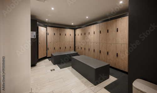 Obraz na plátne Modern gym locker room with wooden lockers and benches