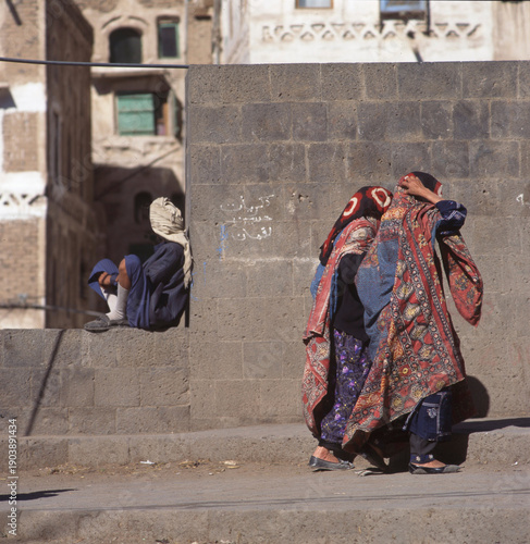 Two veiled Muslim women walking on a Sana street in Yemen