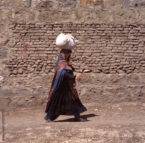 A veiled Muslim woman walks on a Sana a street in Yemen