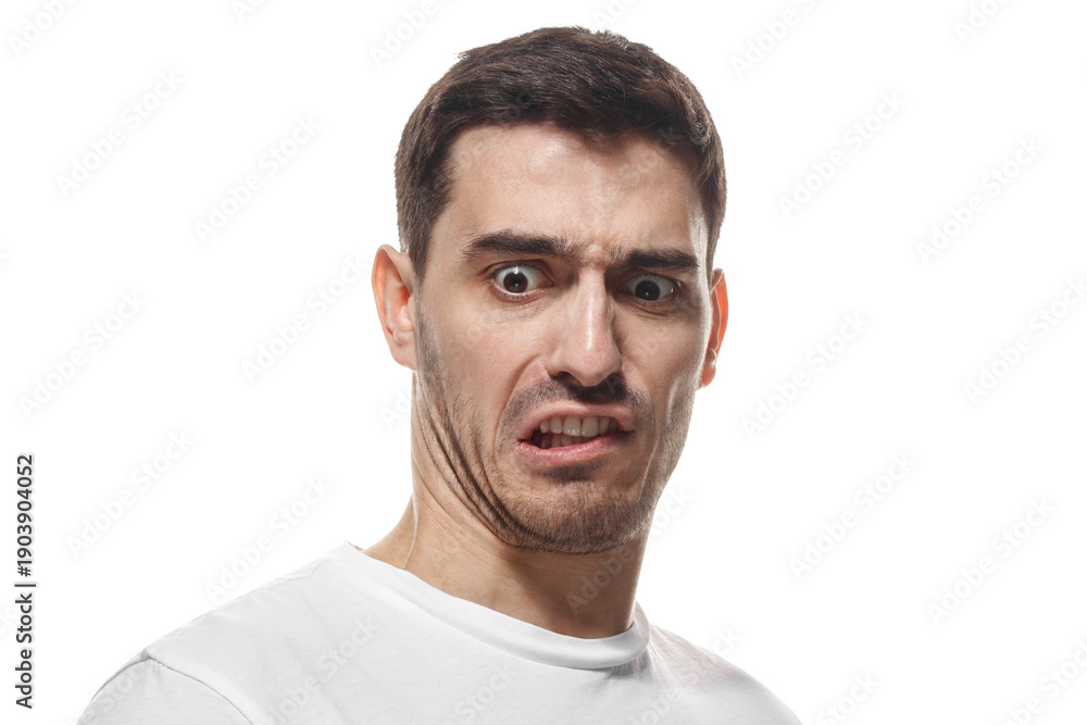 Fototapeta premium Angry man showing teeth with intense disgusted expression and negative emotion
