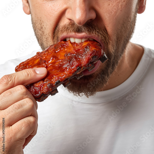 Chef Enjoys Tasty Chicken Wing While Smiling and Wearing a White Uniform in B...