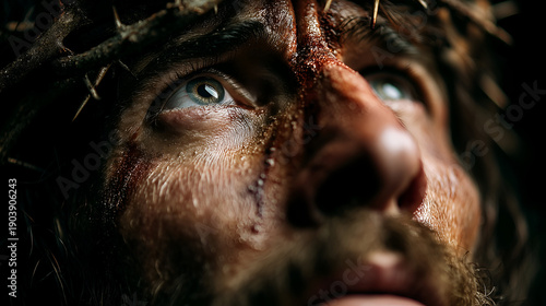 Close up portrait of Jesus Christ with a crown of thorns and blood on his face