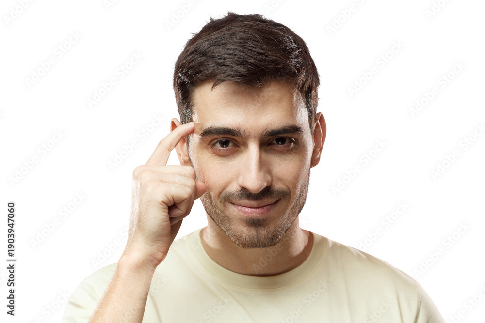 Obraz premium Closeup portrait of young European Caucasian man pictured isolated on pink background pressing finger to temple as if making viewer think more about offer or analyze information better for their good