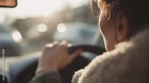 Close-up of a person's hand on the steering wheel of a car. the person is wearing a fur coat and appears to be in the driver's seat.
