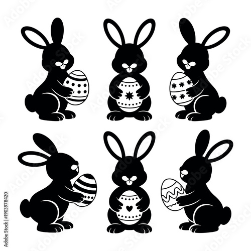 Black silhouettes of Easter bunnies holding eggs