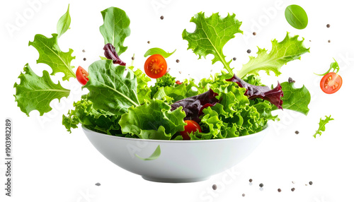 A vibrant salad bowl with fresh greens, tomatoes, and peppercorns, some floating