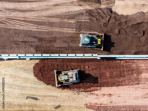 Aerial bulldozer earth leveling construction site