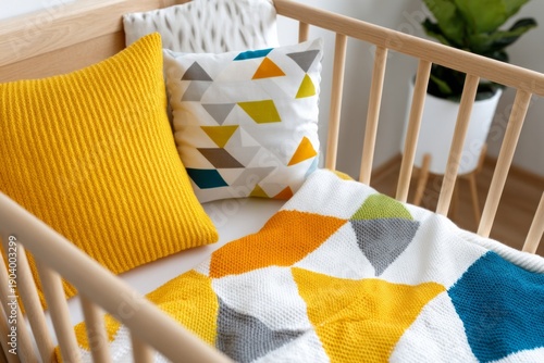 Cozy Baby Bed with Colorful Blankets and Pillows Viewed from Above in a Bright Room