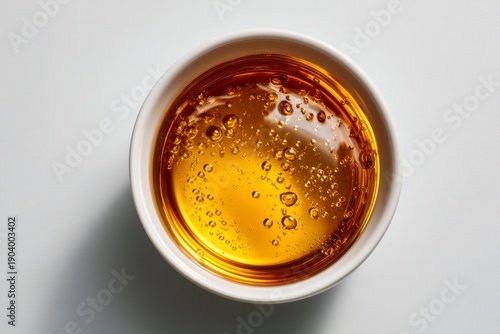 Clear Ramen Broth in a Bowl with Surface Oil Droplets Captured from Above