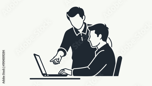 Two men working on laptop computer.