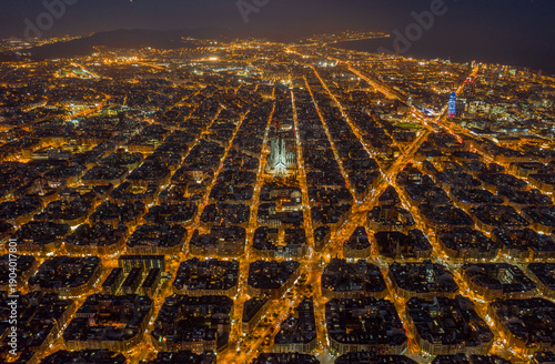 Sticker Aerial night view of Barcelona Eixample grid and Sagrada Familia illuminated, Sp