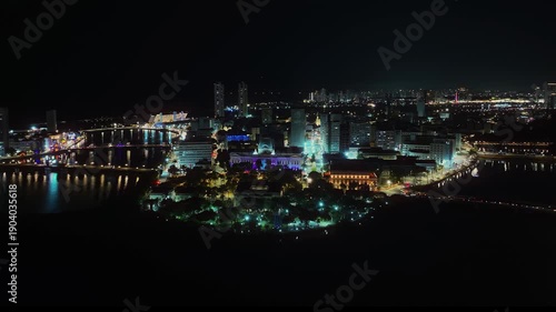 Wallpaper Mural Aerial night view of the city of Recife, Pernambuco, Brazil, highlighting the illuminated urban center and the Palácio do Campo das Princesas along the river.  Torontodigital.ca