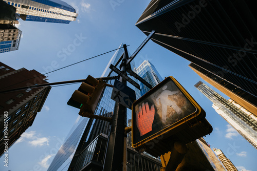 Pedestrian signal with background of high city buildings