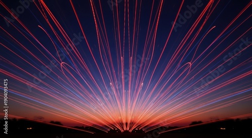 Abstract radiant light trails stretch across a darkening sky in a long exposure shot