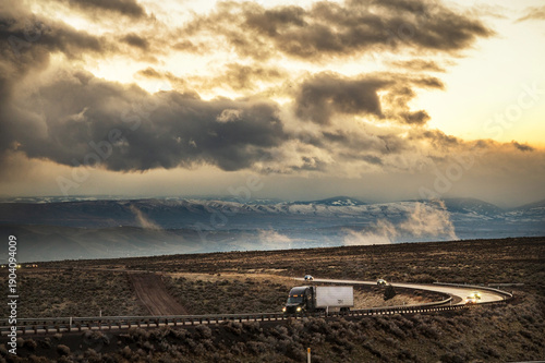 Cars and semi tractor transport trucks travel through  a severe storm along Interstate 84.  The high desert near Boise Idaho, USA.