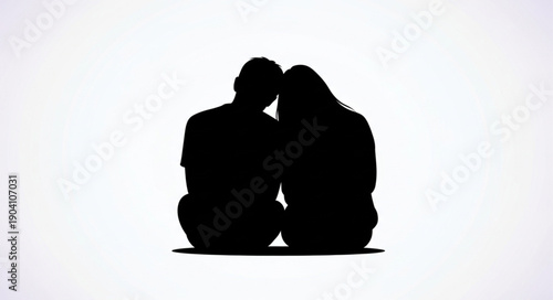 Silhouette of a couple sitting together intimately.