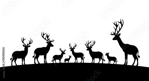 Silhouette herd of deer standing on a hill.