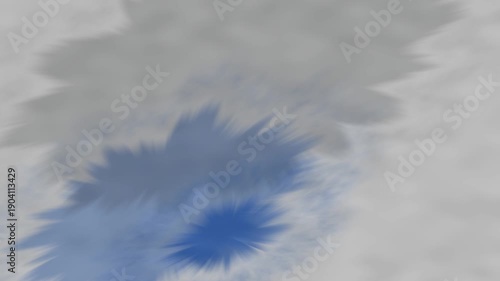 A blurred abstract image featuring soft blue and gray patches against a white background