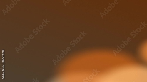 A blurred abstract background with soft circular shapes in warm orange tones