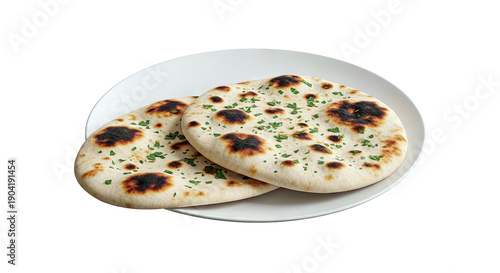 Two freshly baked naan breads with parsley on a white plate