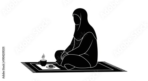 A woman sitting on a prayer mat reading from a book with a candle nearby in a serene environment