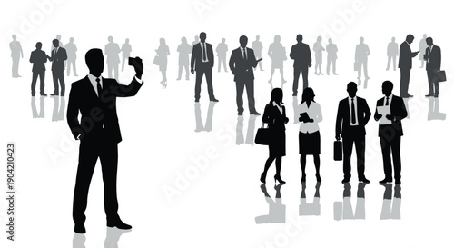 Silhouette of a businessman taking a photograph with a mobile phone while surrounded by a diverse crowd of formally dressed professionals and colleagues at an event