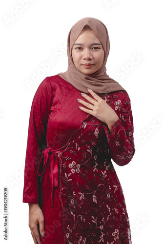 Young asian woman wearing elegant red dress and hijab for cultural celebration