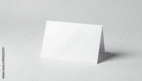 Blank white card standing on table