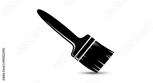 Black paint brush with thick bristles against a plain background