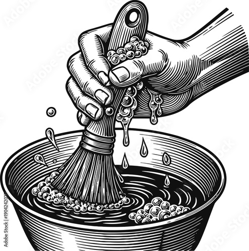 Hand holding brush with soap bubbles over bowl filled with water, cleaning and washing concept